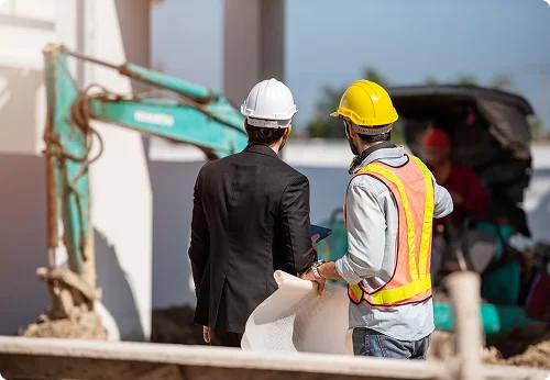 Two construction workers on a job site