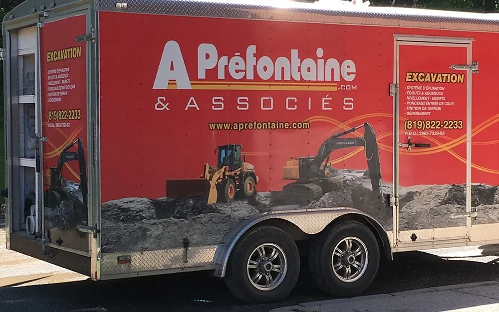 A. Préfontaine & Associés branded trailer lettered ‘Excavation’ with the company phone number on a job site